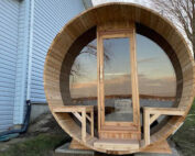 barrel sauna with panoramic window and glass front wall