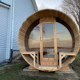 barrel sauna with panoramic window and glass front wall
